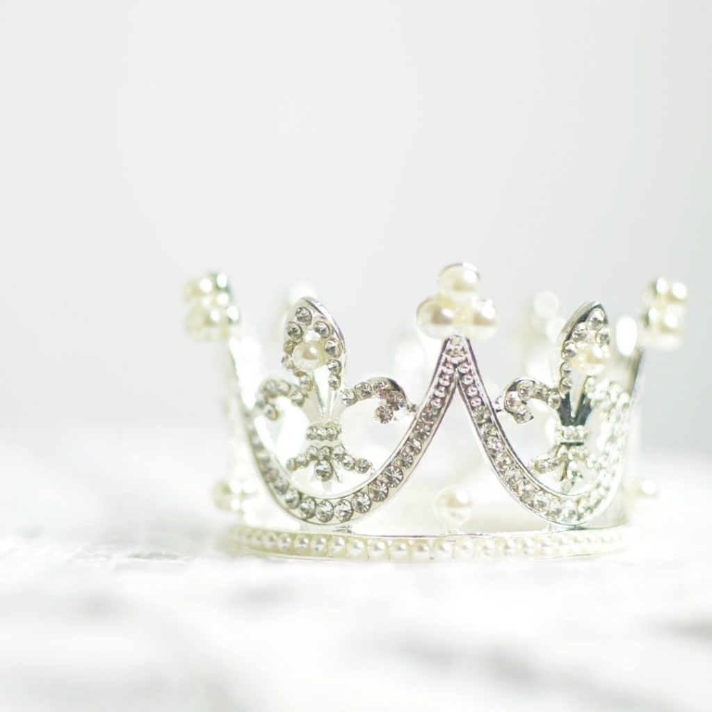 Image of a diamond crown on a bed of white fabric